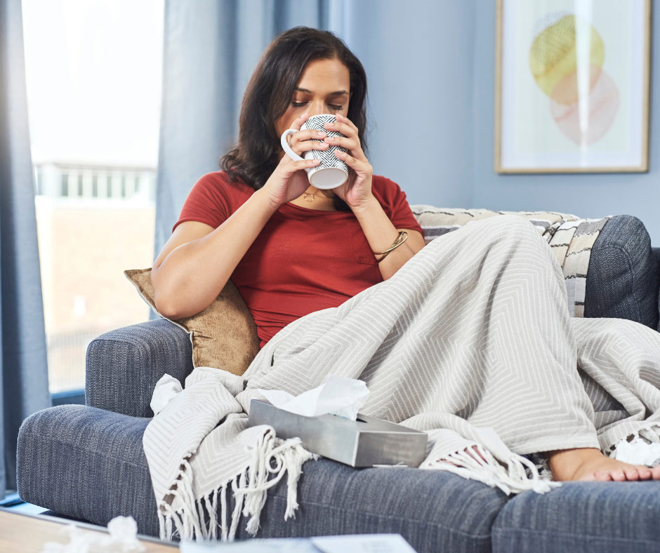 Woman drinking tea in warm house