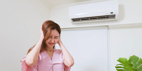 Woman covering ears due to AC Noises