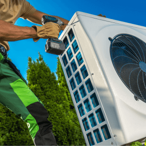 HVAC Technician Installing Large Modern Heat Pump