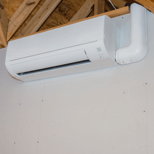 Mini-split ductless air conditioning unit installed in unfinished room